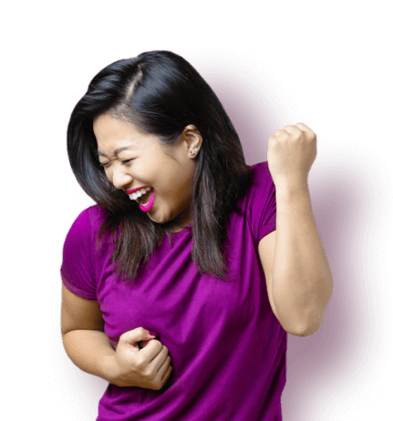 Excited woman in purple shirt raising fist with joy